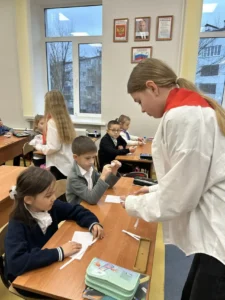 Ученица помогает младшим учащимся